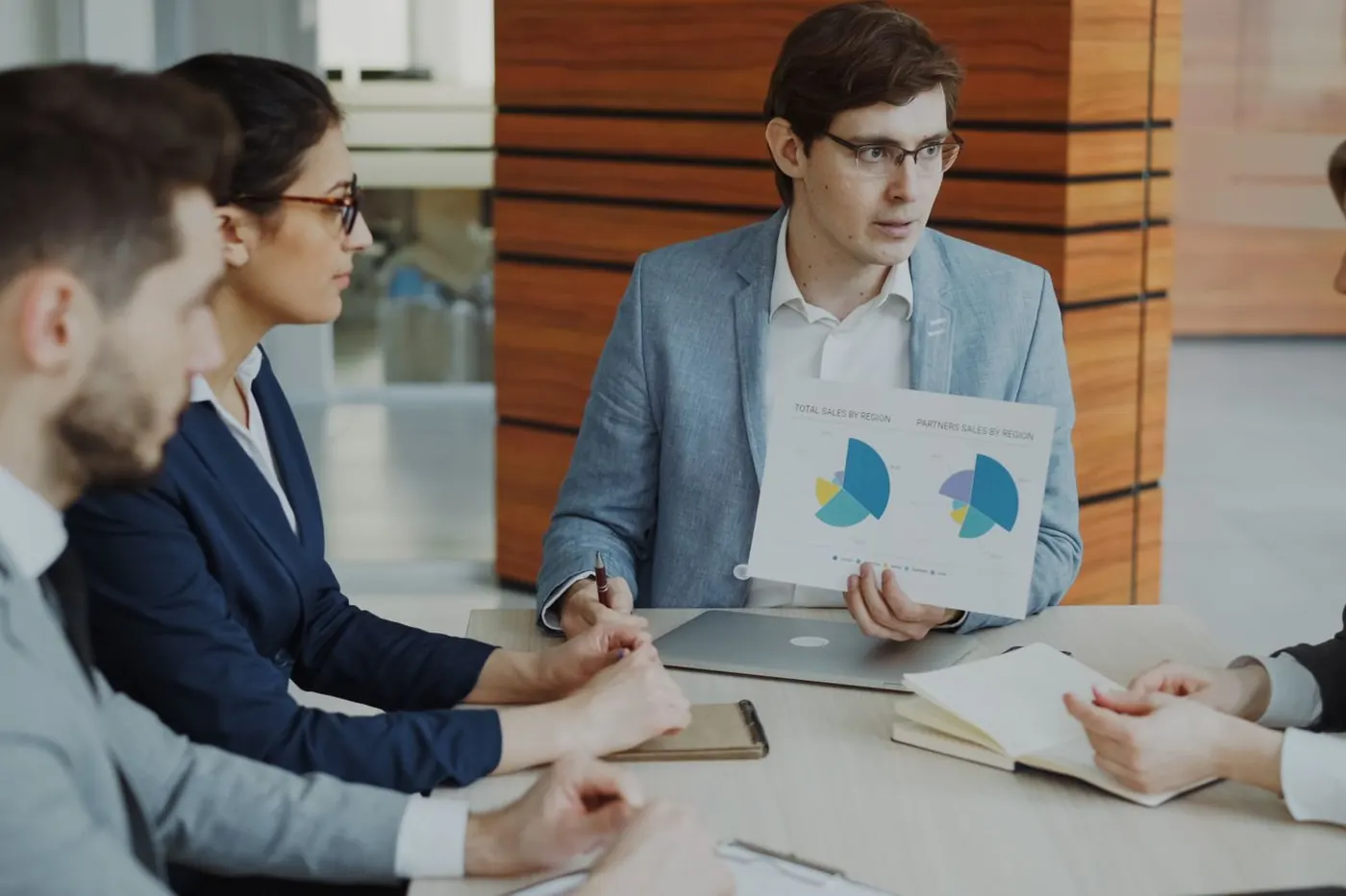 A sales team reviewing numbers together in a meeting